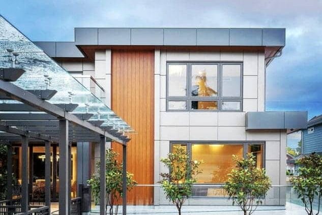 Regular aluminum siding on a house facade, featuring traditional metal panels, even spacing, and a low-maintenance painted surface.