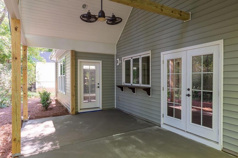 Horizontal vinyl siding on a house wall, displaying traditional overlapping panels, consistent shadow lines, and a durable